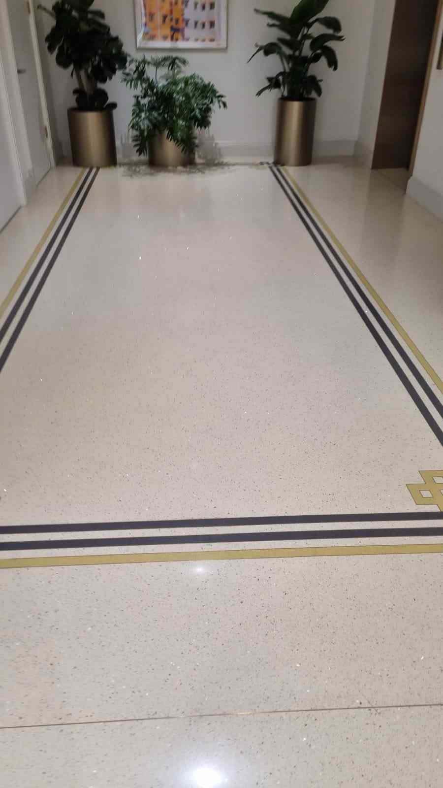 Terrazzo lobby floor finished with a gold and black border